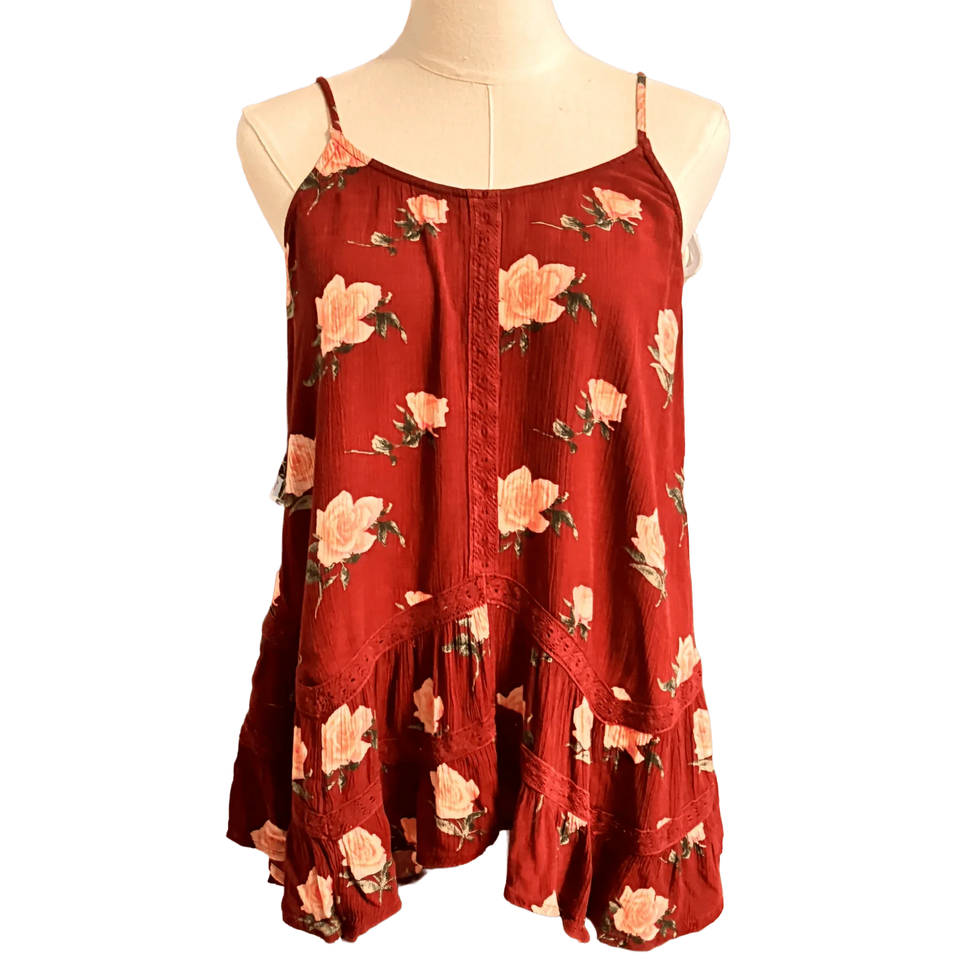 Red floral sleeveless blouse with ruffle hem and thin straps on a mannequin