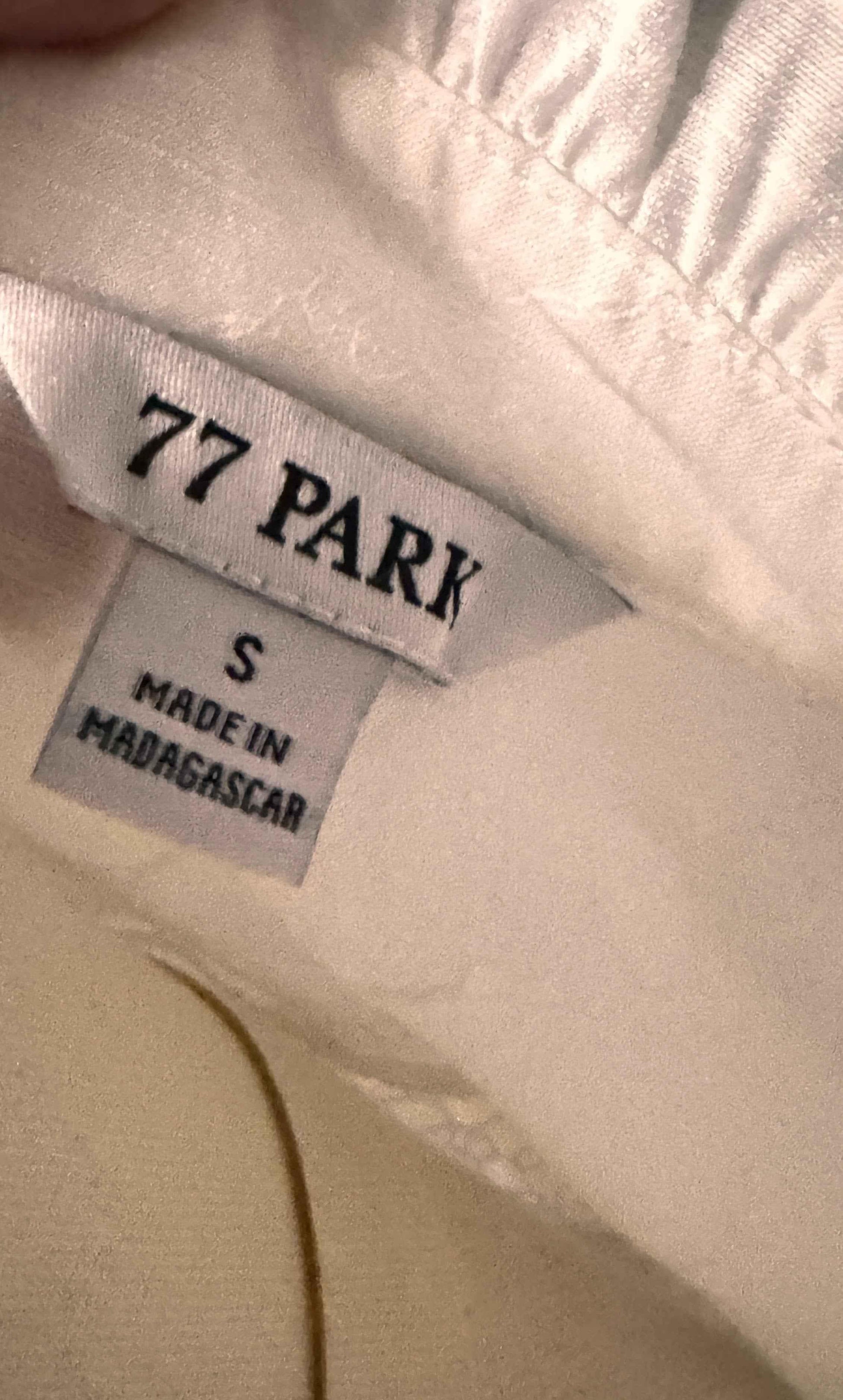 77 PARK clothing label, size S, made in Madagascar, sewn on light fabric