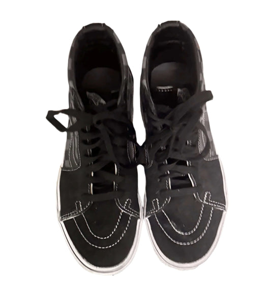 Top view of black Vans high-top shoes with white stitching on white background