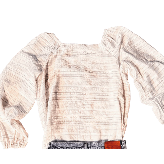 White Ann Taylor blouse with textured stripes and puffed long sleeves, paired with jeans.