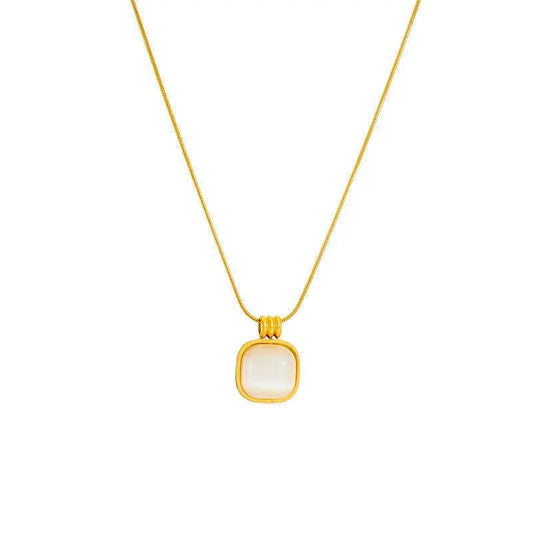 Gold chain necklace with square white stone pendant on white background